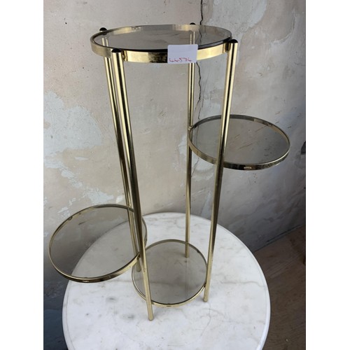 27 - A BRASS AND GLASS PLANTSTAND