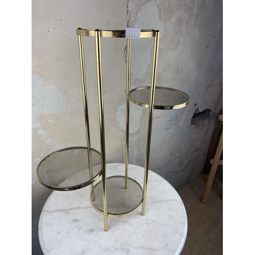 27 - A BRASS AND GLASS PLANTSTAND