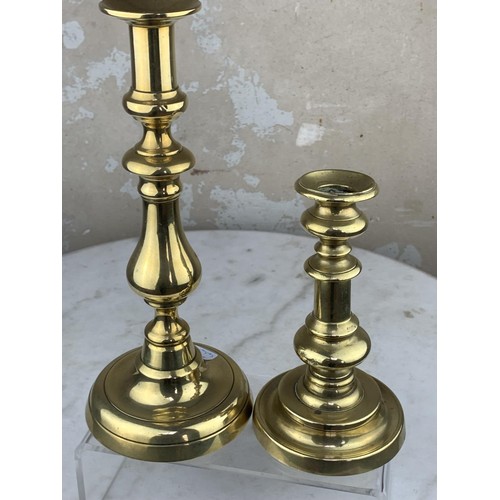 57 - 2 GRADUATED BRASS CANDLE STICKS TALLEST 10