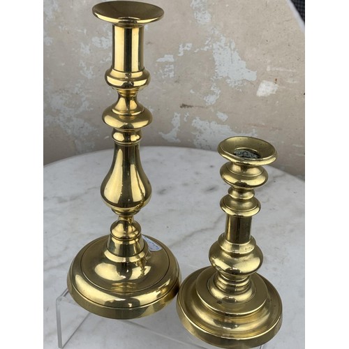 57 - 2 GRADUATED BRASS CANDLE STICKS TALLEST 10