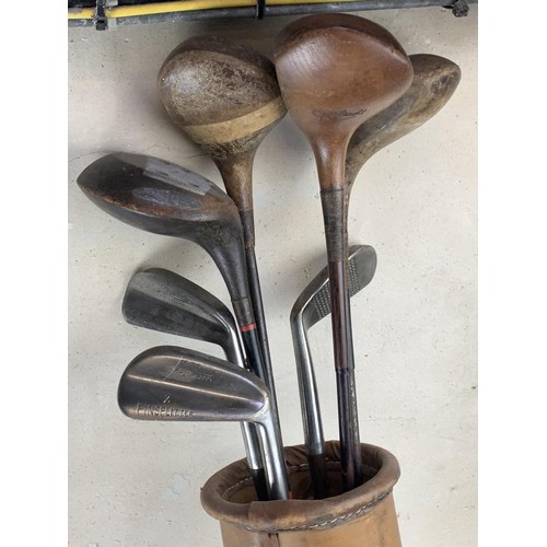 158 - ANTIQUE HICKORY GOLF CLUBS IN A LEATHER BAG