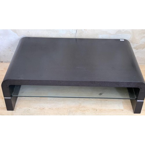 124 - AN EBONY/GLASS COFFEE TABLE 45x28x14