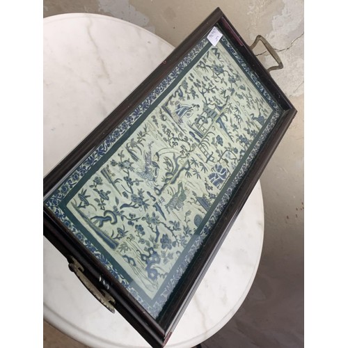 128 - A WOODEN TRAY WITH CHINESE  SILK  UNDER GLASS 21X9.5