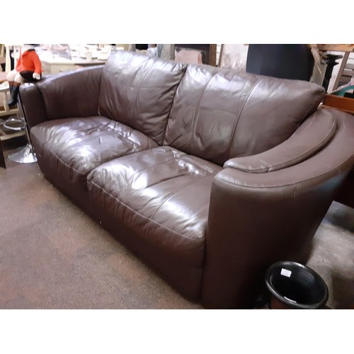 151 - A BROWN LEATHER CURVED ARMED SOFA