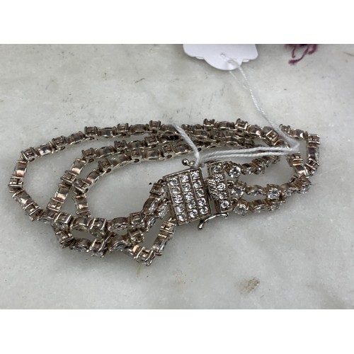 229 - A 3 STRAND SILVER AND CRYSTAL SET BRACELET