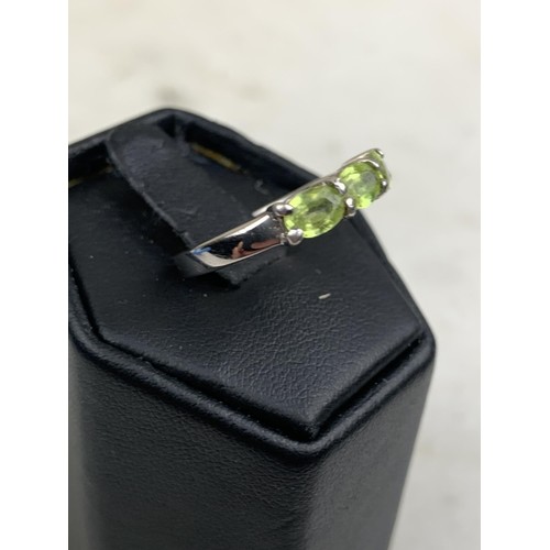 286 - A SILVER AND PERIDOT 3 STONE RING