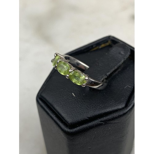 286 - A SILVER AND PERIDOT 3 STONE RING