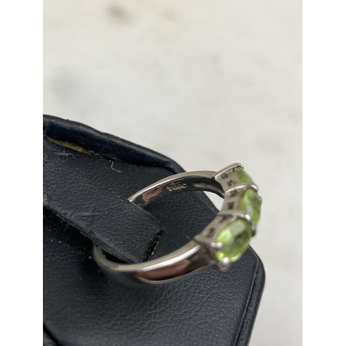 286 - A SILVER AND PERIDOT 3 STONE RING