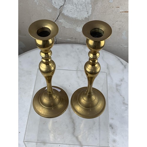 406 - A PAIR OF BRASS CANDLESTICKS 9