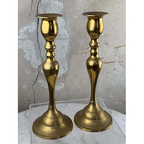 406 - A PAIR OF BRASS CANDLESTICKS 9