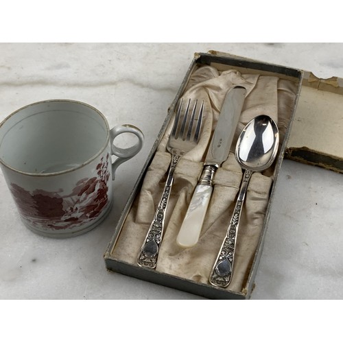 417 - A CHILDS CUTLERY SET WITH M.O.P HANDLES AND AN ANTIQUE MUG