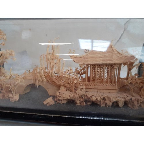 438 - A SMALL DISPLAY WITH AN ORIENTAL CORK CARVING 9 X 5