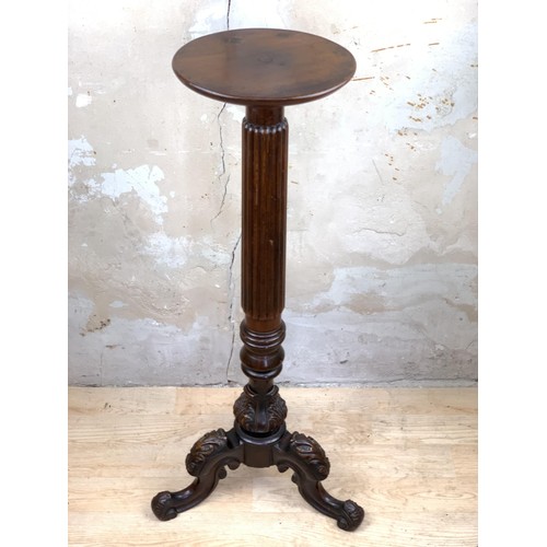 491 - A VICTORIAN REEDED COLUMN TORCHERE TO A HEAVILY CARVED BASE