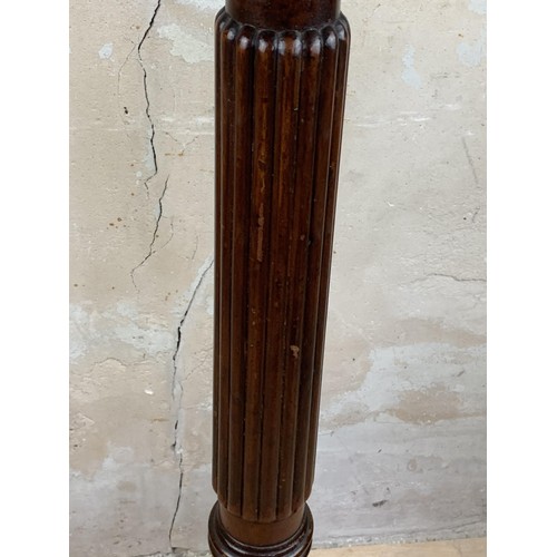 491 - A VICTORIAN REEDED COLUMN TORCHERE TO A HEAVILY CARVED BASE