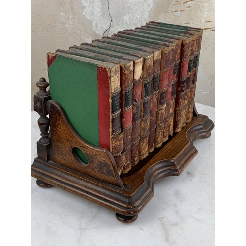 523 - AN ANTIQUE MAHOGANY BOOK STAND HOLDER AND BOOKS