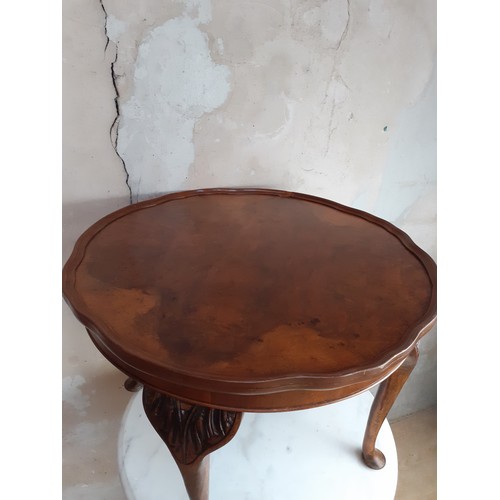 448 - A BURR WALNUT CARD TABLE WITH A PIE CRUST EDGE