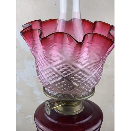 487 - A RUBY BOWL OIL LAMP WITH A RUBY TIPPED SHADE