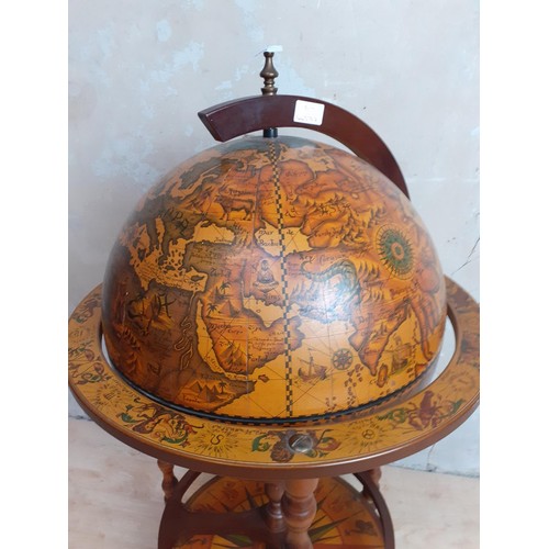 489 - A FLOOR STANDING GLOBE DRINKS CABINET ON WHEELS