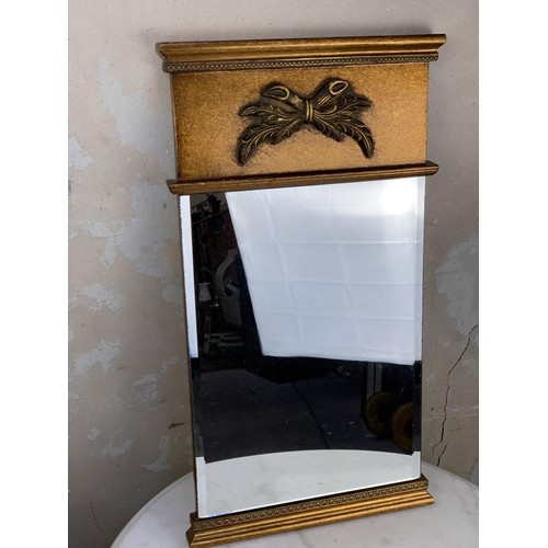 350A - AN ORNATE GILT TRIMMED MIRROR 23.5X13