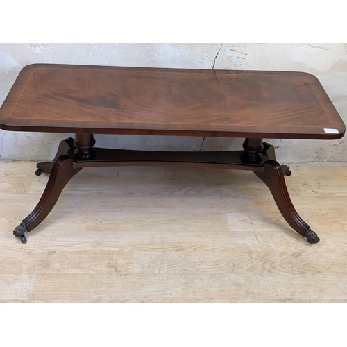 20A - A FLAME MAHOGANY COFFEE TABLE ON STRECHER BASE