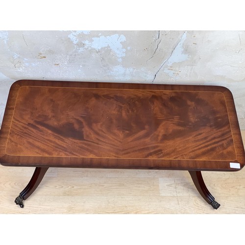 20A - A FLAME MAHOGANY COFFEE TABLE ON STRECHER BASE