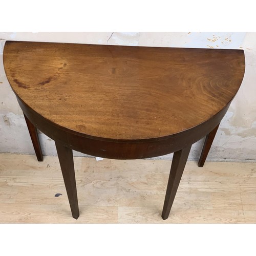 10 - AN ANTIQUE MAHOGANY DEMI LUNE TABLE