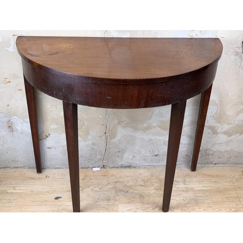 10 - AN ANTIQUE MAHOGANY DEMI LUNE TABLE