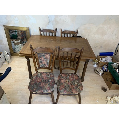 103 - AN OAK DRAW LEAF TABLE AND 6 CHAIRS