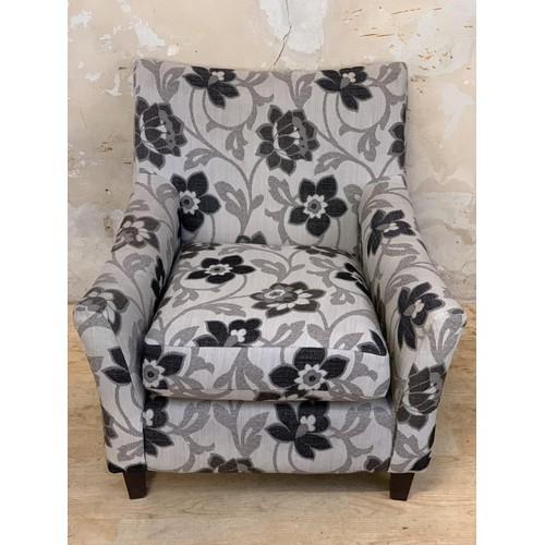 138 - A FLORAL PATTERN ARMCHAIR