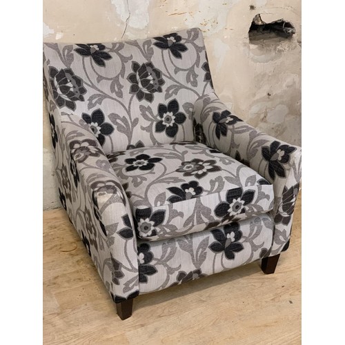 138 - A FLORAL PATTERN ARMCHAIR