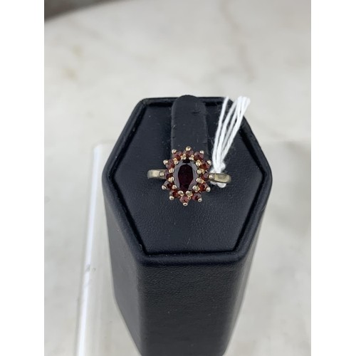 222 - A SILVER GILT GARNET SET RING