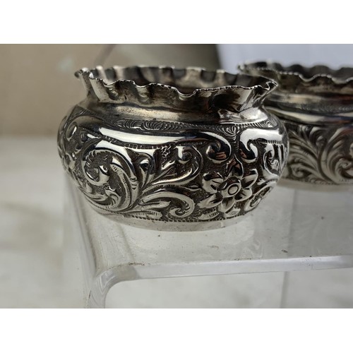 253 - A PAIR OF BIRMINGHAM SILVER EMBOSSED SALTS 44.7grms