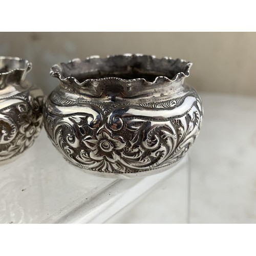 253 - A PAIR OF BIRMINGHAM SILVER EMBOSSED SALTS 44.7grms