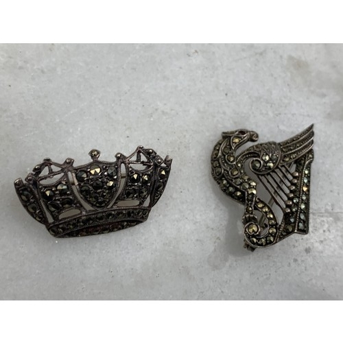 209 - A SILVER MARCASITE CROWN BROOCH & A DRAGON HARP BROOCH SET WITH RUBY