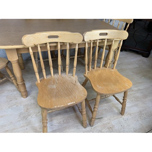 150 - AN OAK DINING TABLE AND 6 CHAIRS