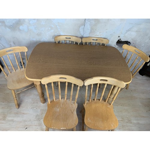 150 - AN OAK DINING TABLE AND 6 CHAIRS