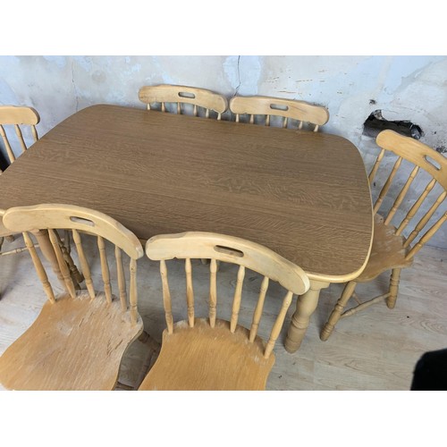 150 - AN OAK DINING TABLE AND 6 CHAIRS