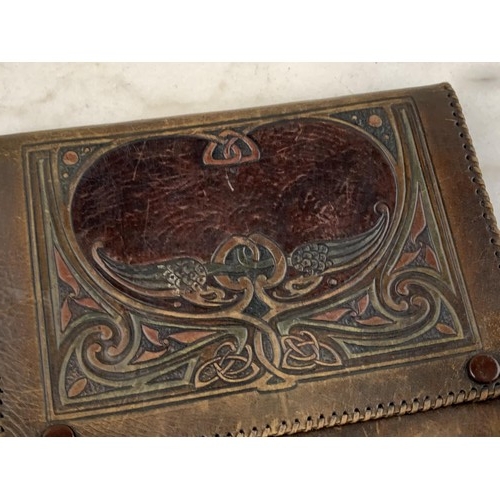 341 - A VERY OLD HAND CRAFTED SILK LINED LEATHER CLUTCH STYLE BAG HEAVILY EMBOSSED WITH A CELTIC DESIGN