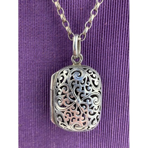 412 - A PIERCED SILVER LOCKET ON A SILVER CHAIN