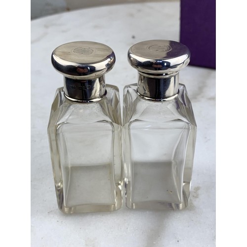 433 - A PAIR OF SILVER TOPPED BOTTLES