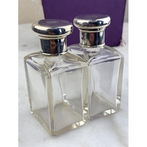 433 - A PAIR OF SILVER TOPPED BOTTLES