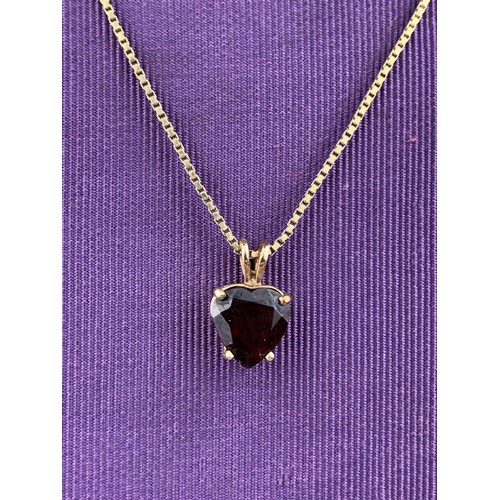 475 - A QUALITY 9CT GOLD GARNET SET HEART PENDANT ON A LONG 9CT CHAIN