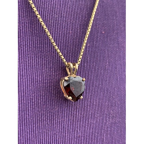 475 - A QUALITY 9CT GOLD GARNET SET HEART PENDANT ON A LONG 9CT CHAIN