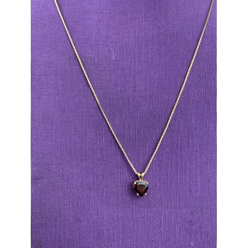 475 - A QUALITY 9CT GOLD GARNET SET HEART PENDANT ON A LONG 9CT CHAIN