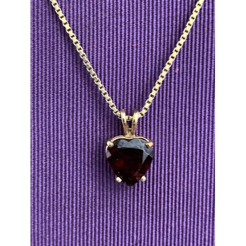 475 - A QUALITY 9CT GOLD GARNET SET HEART PENDANT ON A LONG 9CT CHAIN