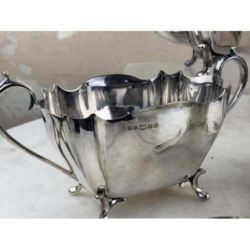 486 - A 3 PIECE SILVER PLATED TEA SET & MATCHING SUGAR TONGS