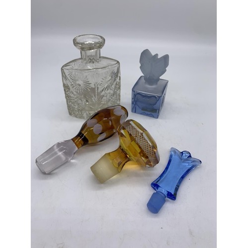 578 - 3 COLOURED GLASS DECANTER STOPPERS & 2 PERFUME BOTTLES