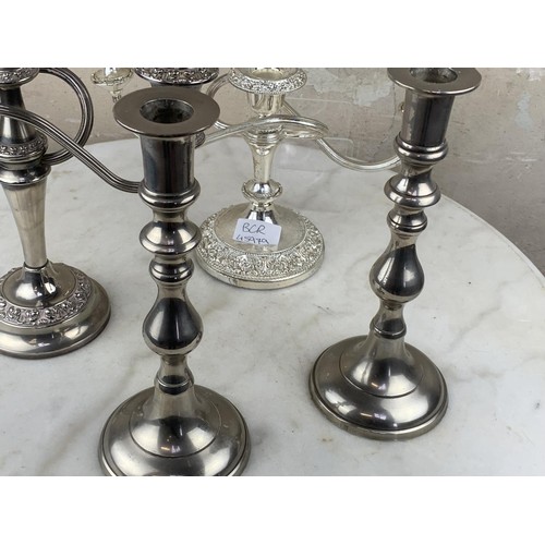 22 - A PAIR OF PLATED CANDLELABRA & A PAIR OF PLATED CANDLESTICKS