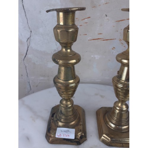 97 - A PAIR OF BRASS CANDLESTICKS AND FINGER SCONCE