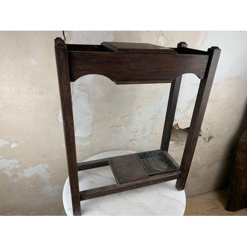 136 - A SMALL OAK STICKSTAND WITH STORAGE 21 x 9 x 26